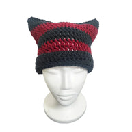 Handmade by Erika Liesel black and red striped crochet cat-ear beanie on a white mannequin head.