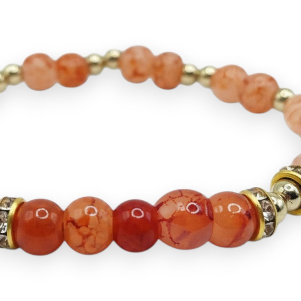 Handmade by Erika Liesel Sunset Ember stretch bracelet with peach, coral, and orange glass beads and rhinestone accents