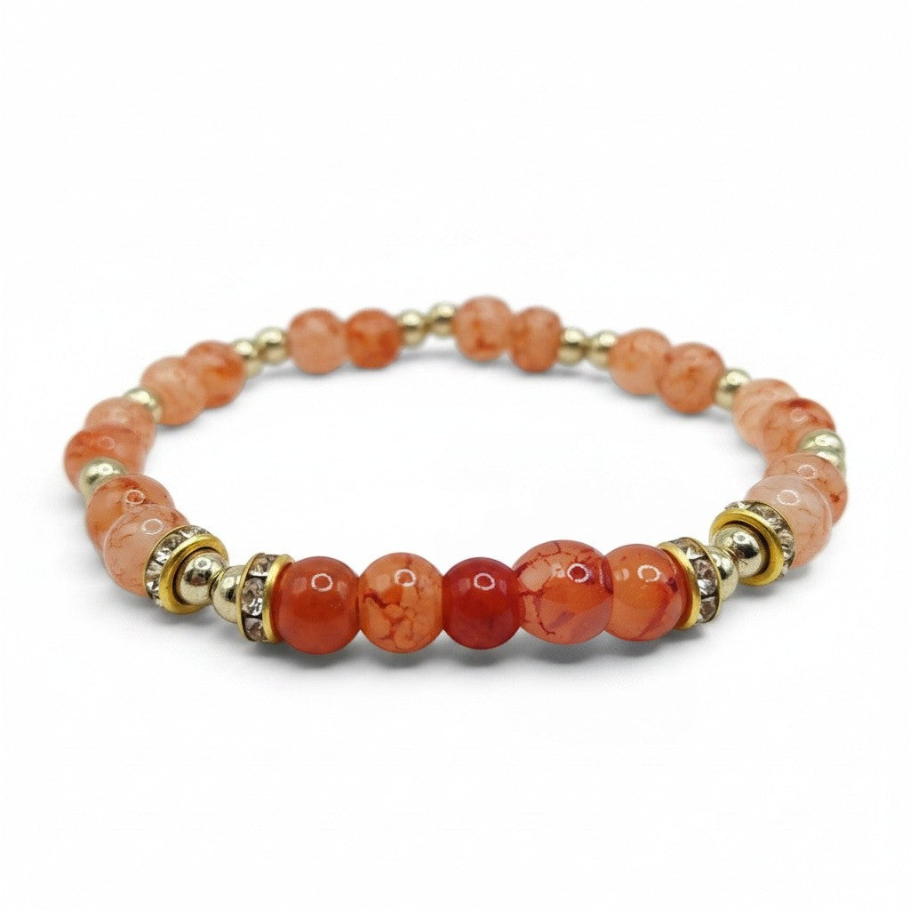 Handmade by Erika Liesel Sunset Ember stretch bracelet with peach, coral, and orange glass beads and gold rhinestones.