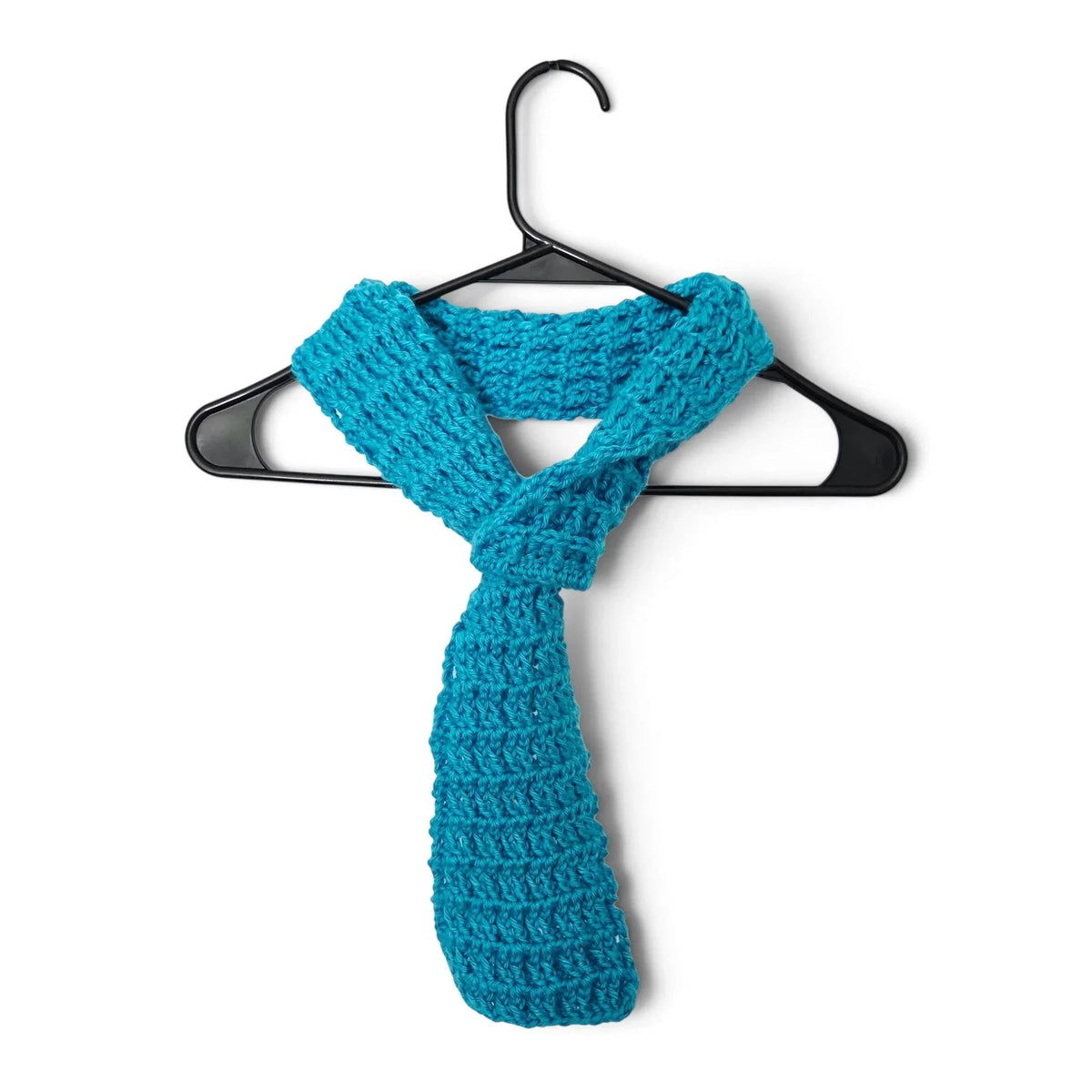 Handmade by Erika Liesel teal crochet scarf with a convenient keyhole design hanging on a black hanger
