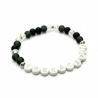 Handmade by Erika Liesel Treats Pls stretch bracelet with matte black glass, iridescent crystal, and letter beads.