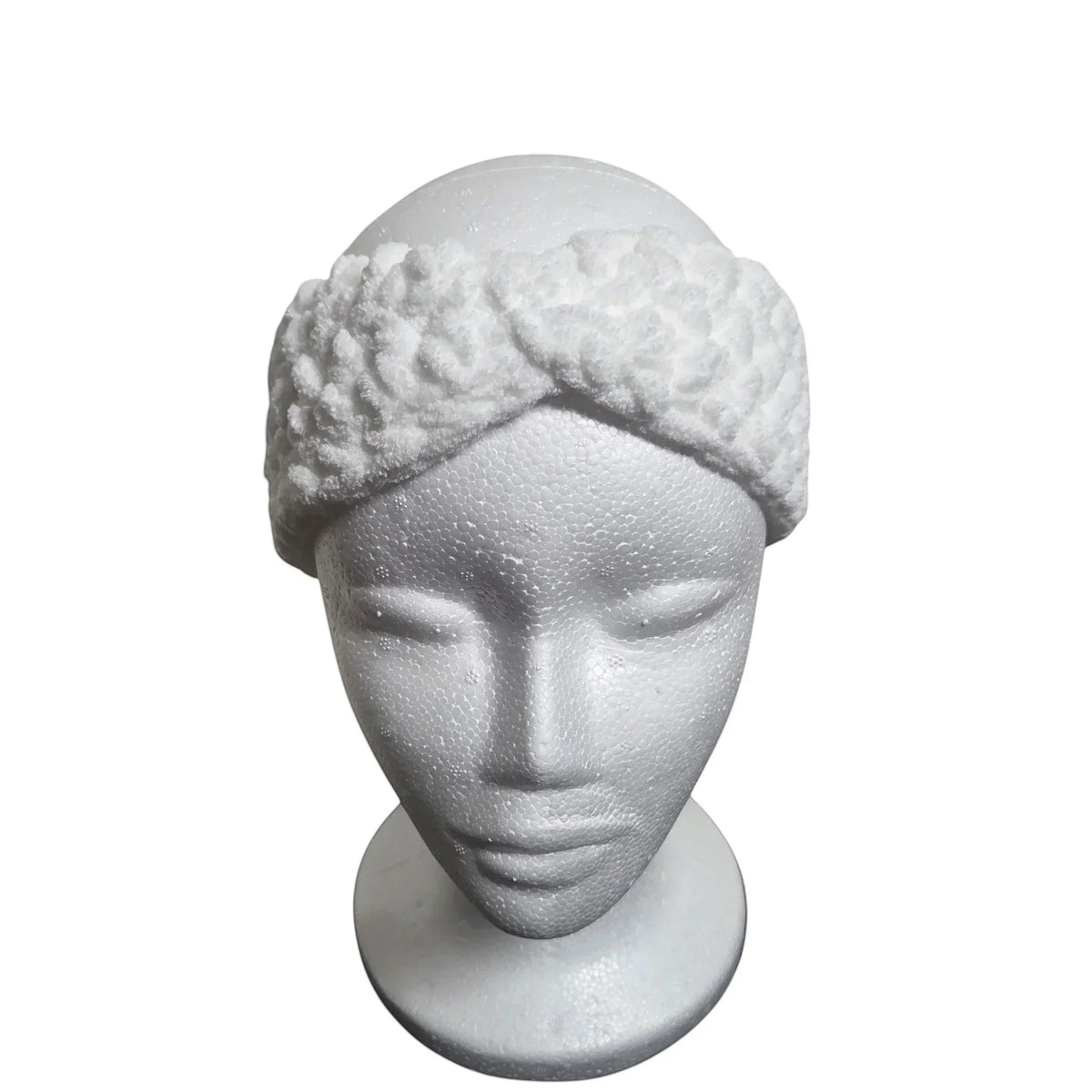 Handmade by Erika Liesel white crochet kids ear warmer with a textured twist design on a mannequin head.