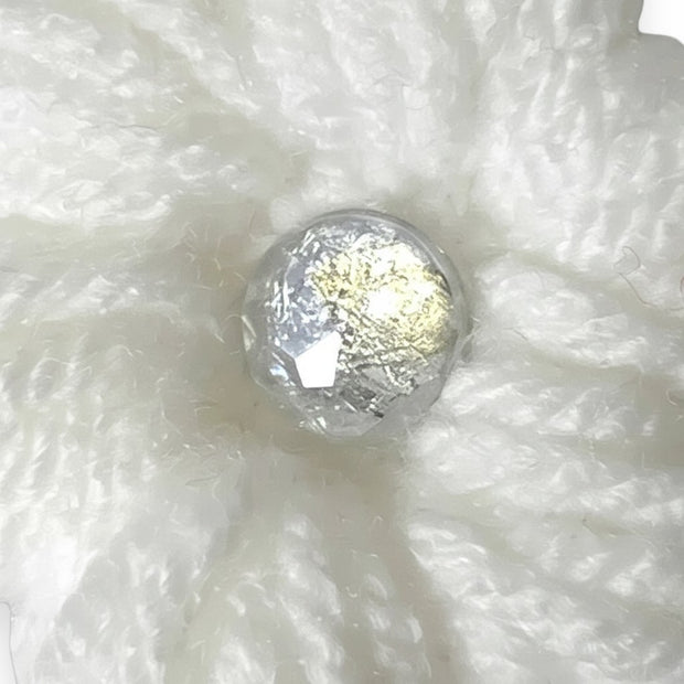 Handmade by Erika Liesel white crochet flower clip with a shimmering center accent for seasonal gnome decor.