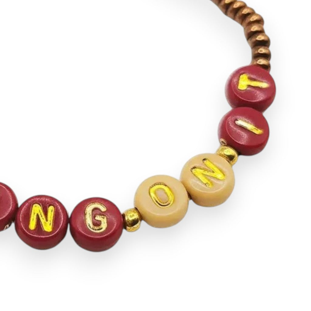 Handmade by Erika Liesel Working On It bracelet with 4mm glass beads, gold-foil letters, and gold accents.