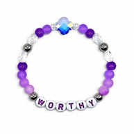 Handmade by Erika Liesel Worthy stretch bracelet with purple crystal beads, sterling silver accents, and letter beads.
