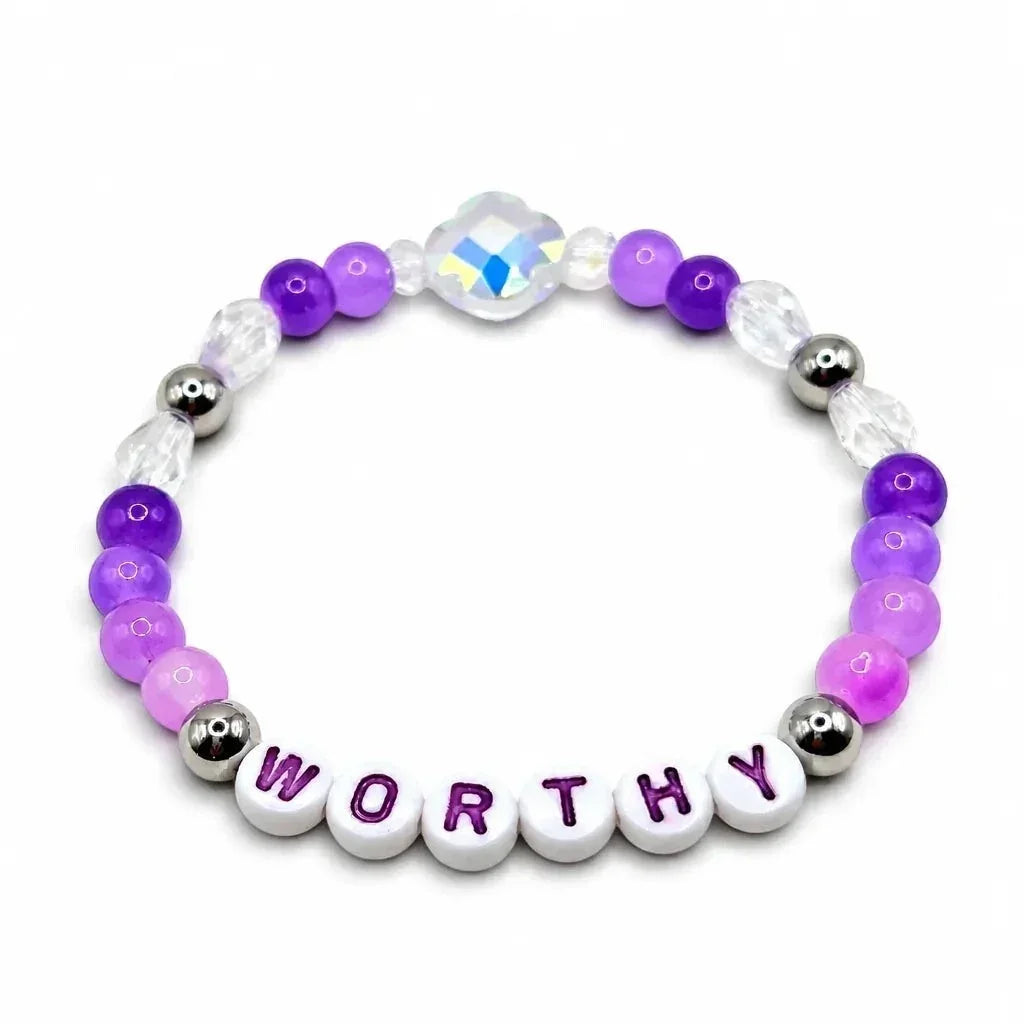 Handmade by Erika Liesel Worthy stretch bracelet with purple crystal beads, sterling silver accents, and letter beads.