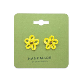 Handmade by Erika Liesel yellow daisy crochet stud earrings with glass bead centers on a green display card.