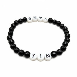 Handmade by Erika Liesel Yin & Yang stretch bracelet with black glass beads and white letter beads on elastic cord.