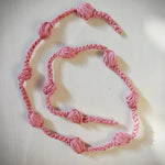 Handmade pink crochet necklace with knotted beads, cozy and creative design