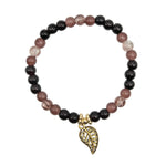 A beaded stretch bracelet featuring alternating glossy black and dusty rose beads, accented with clear crystal-like beads, and finished with a dangling antique gold leaf charm, displayed on a clean white background.