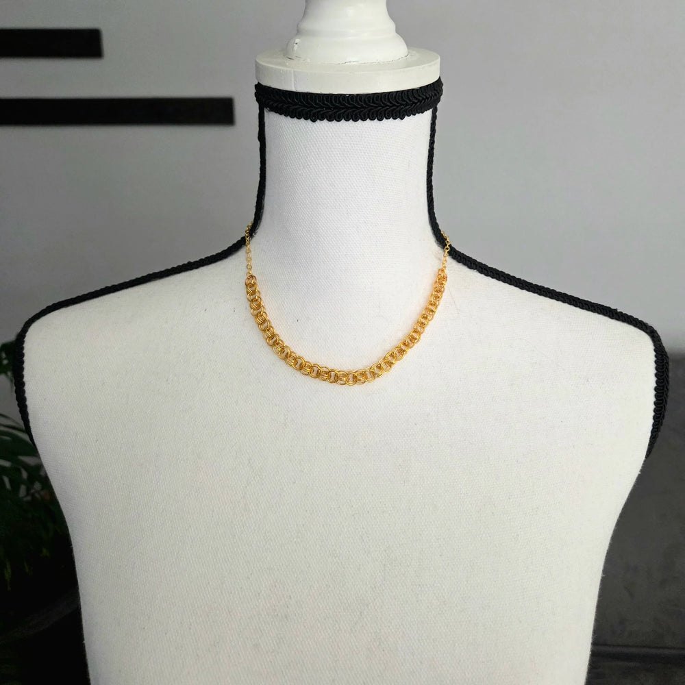 Gold chain necklace on white mannequin with black crocheted trim, handmade jewelry for everyday wear