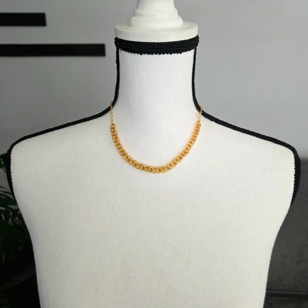Gold chain necklace on white mannequin with black crocheted trim, handmade jewelry for everyday wear