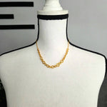 Gold chain necklace on white mannequin with black crochet trim, handmade crochet accessory