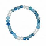 A beaded stretch bracelet featuring alternating light blue marbled beads and translucent white beads, displayed on a clean white background.
