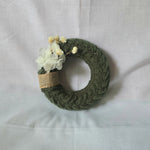 Handmade crochet wreath with dried flowers and burlap ribbon, cozy home decor