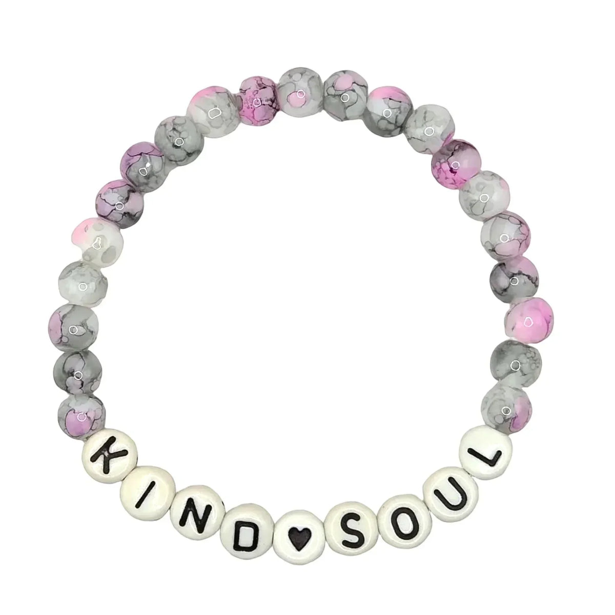 A beaded stretch bracelet on a light gray background, featuring marbled gray and pink beads, white beads spelling 'KIND SOUL' with a small black heart, and a clear elastic band.