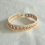 Handmade crochet bracelet with cream and peach pattern, gold clasp, cozy boho accessory