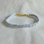 Delicate light blue crocheted bracelet with gold clasp, handmade for everyday comfort and style.