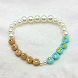 Pearl bracelet with 'LITTLE TREAT' letter beads in tan and teal, handmade cozy accessory