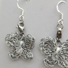 Handmade by Erika Liesel silver crochet butterfly drop earrings with crystal bead accents and sterling silver wires.