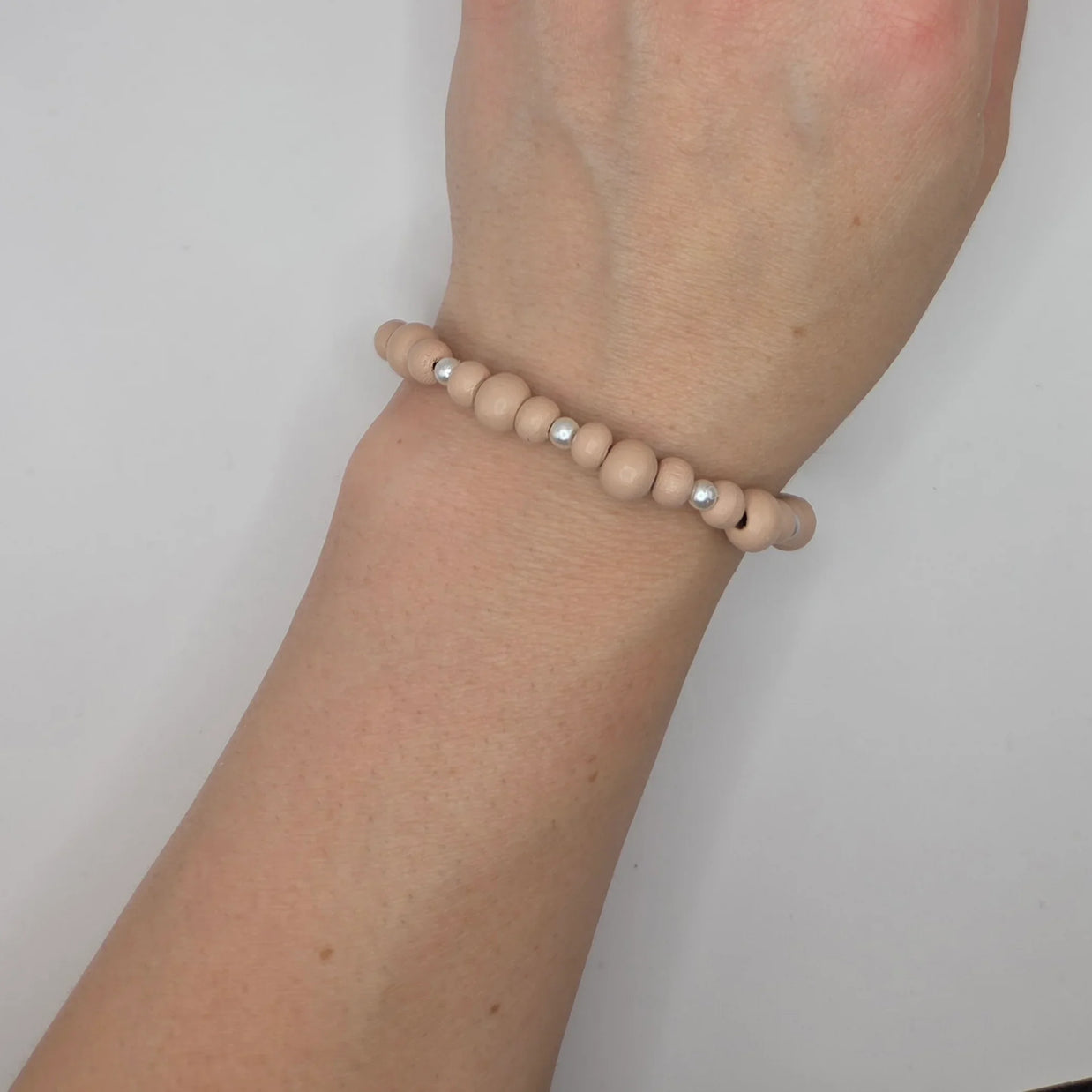 Handmade wooden bead bracelet with silver accents, cozy minimalist wrist accessory