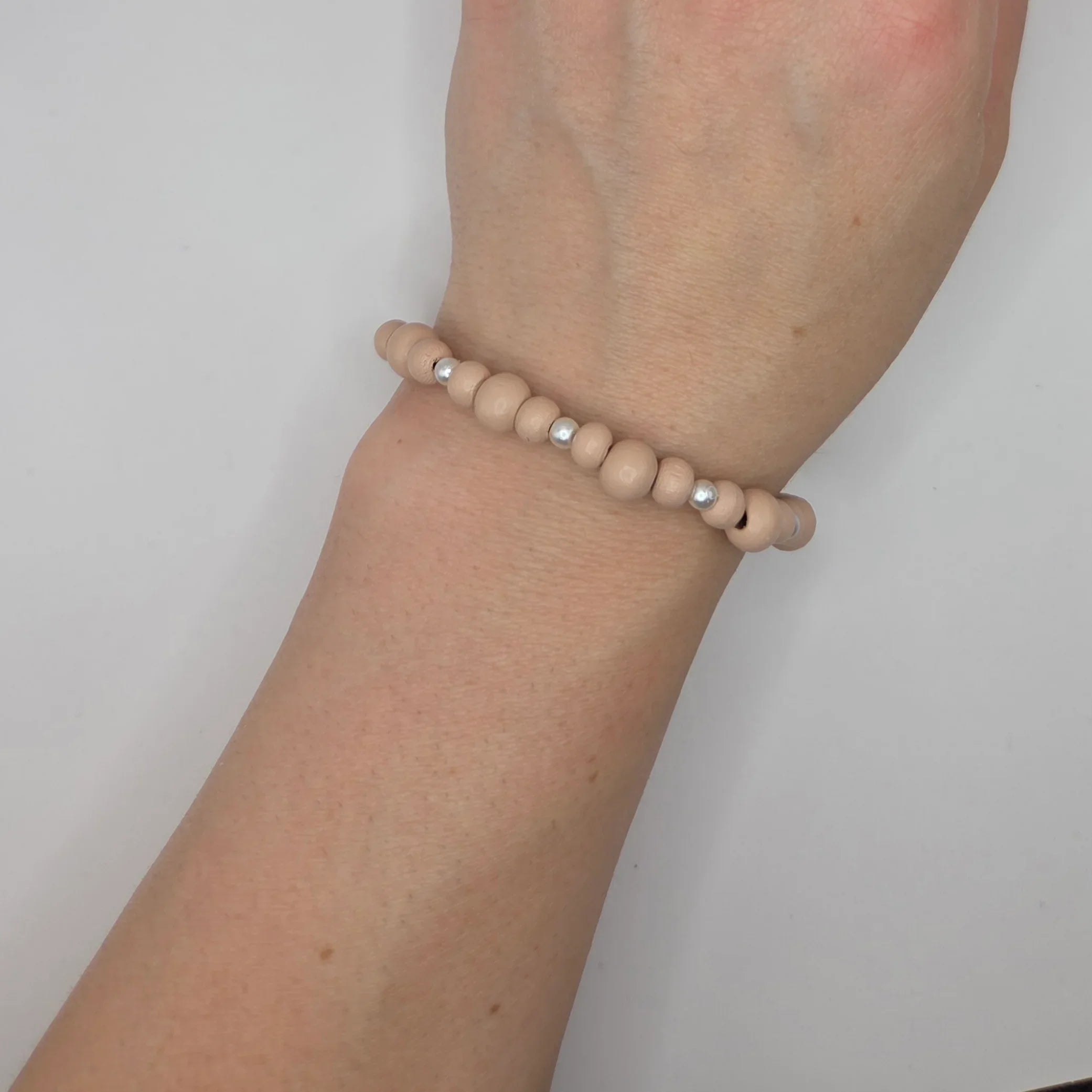 Handmade wooden bead bracelet with silver accents, cozy minimalist wrist accessory