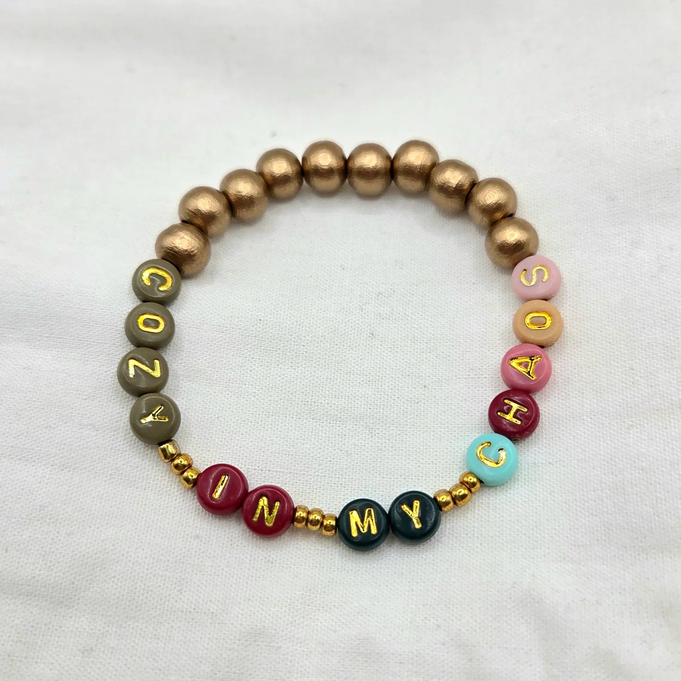 Cozy in My Chaos beaded bracelet with gold letter beads and colorful accents, handmade for comfort and creativity.