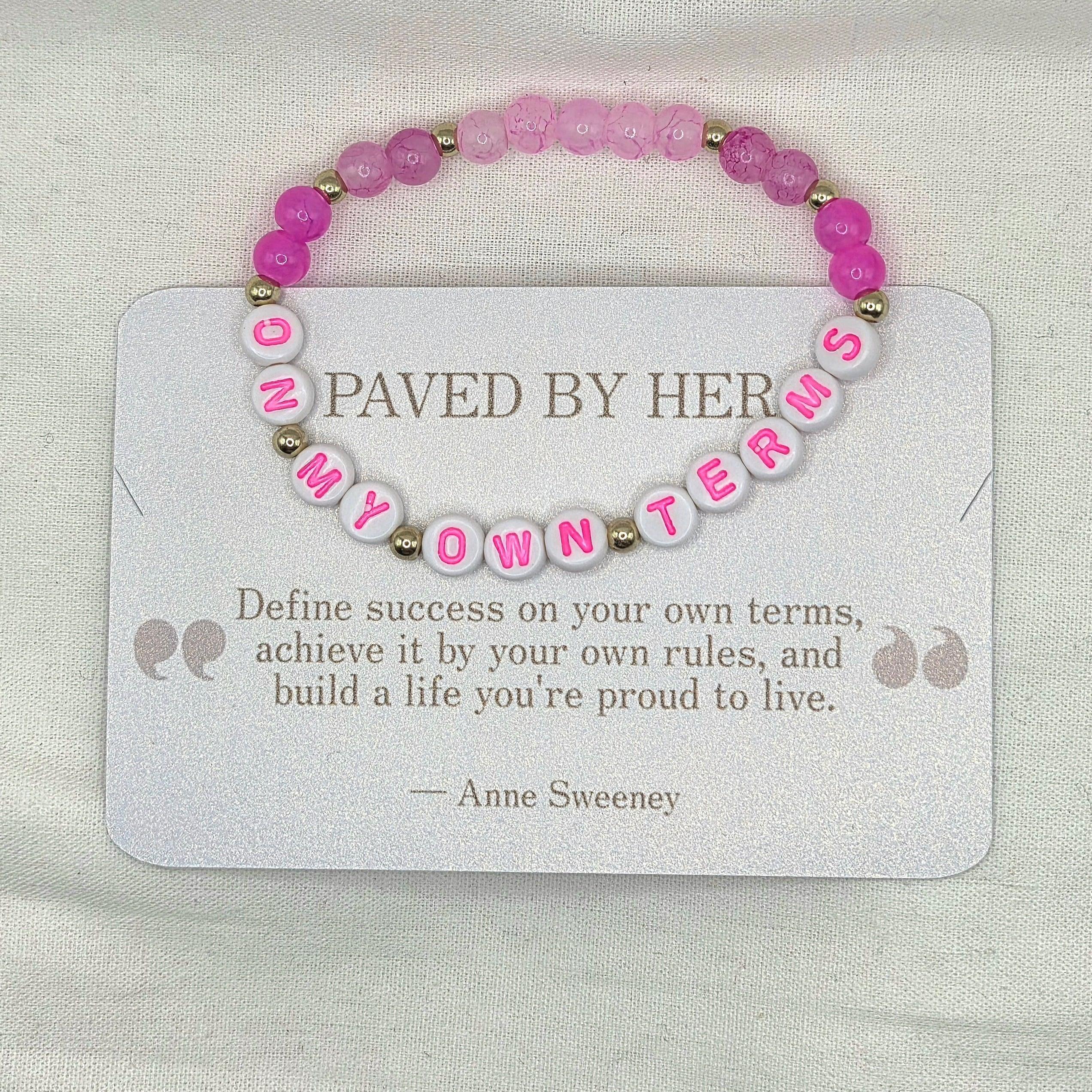 Pink beaded bracelet with 'ON MY OWN TERMS' letter beads, displayed on inspirational card.