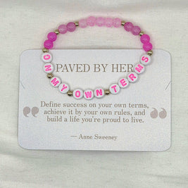Pink beaded bracelet with 'ON MY OWN TERMS' letter beads, displayed on inspirational card.
