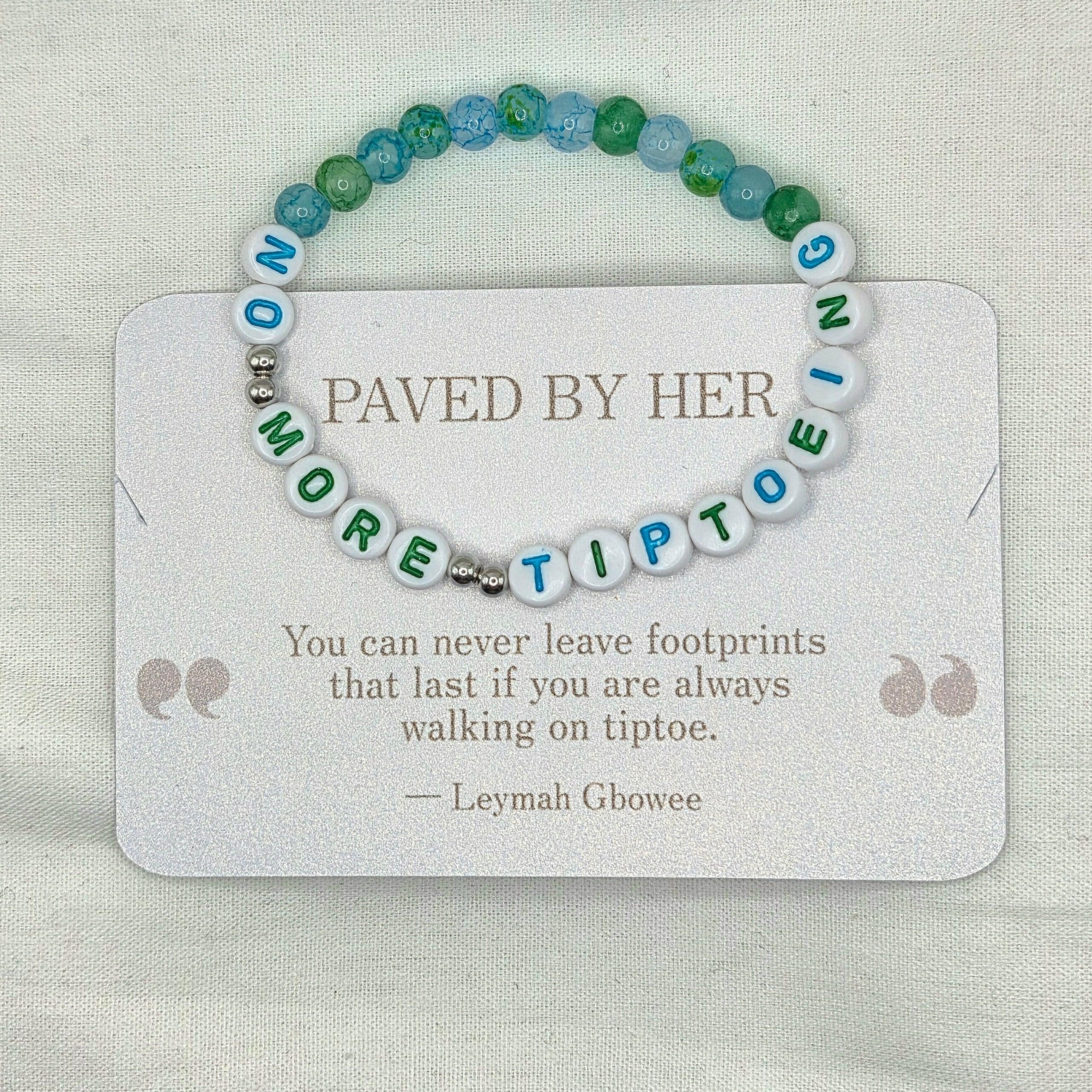 Handmade beaded bracelet with 'NO MORE TIPTOE' letter beads, blue and green accent beads, on a card with inspirational quote.