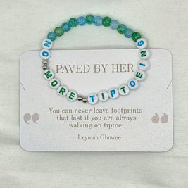 Handmade beaded bracelet with 'NO MORE TIPTOE' letter beads, blue and green accent beads, on a card with inspirational quote.