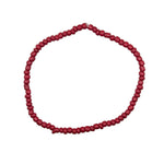 A single strand of dark red cylindrical beads arranged in a circle on a plain white background.