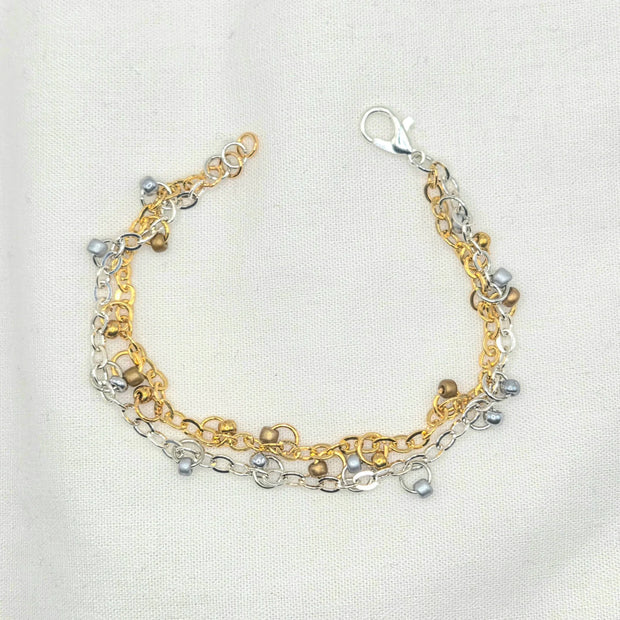 Handmade gold and silver chain bracelet with pearl accents, perfect for everyday wear or gifting.