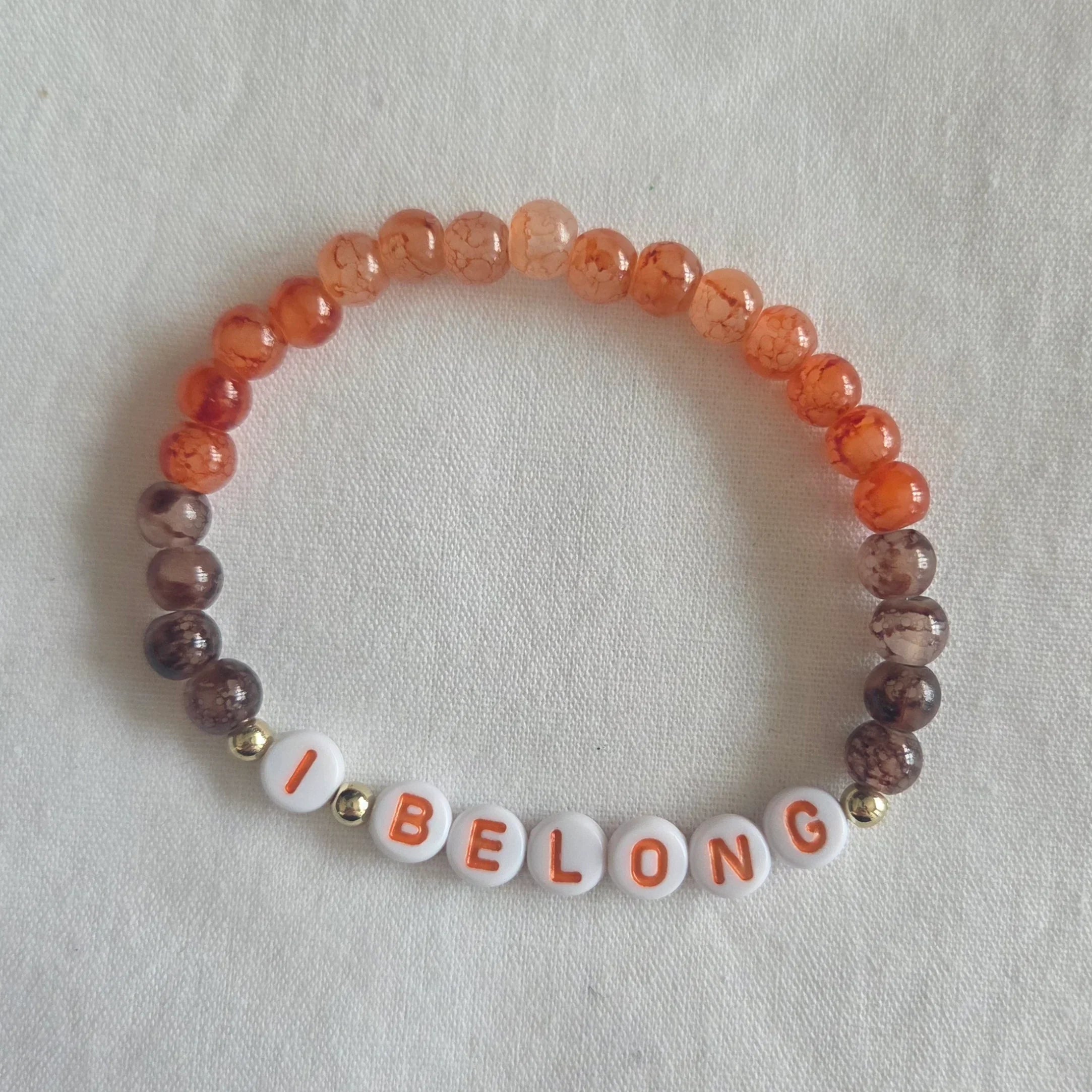 I BELONG beaded bracelet with orange and brown marbled beads, cozy handmade accessory