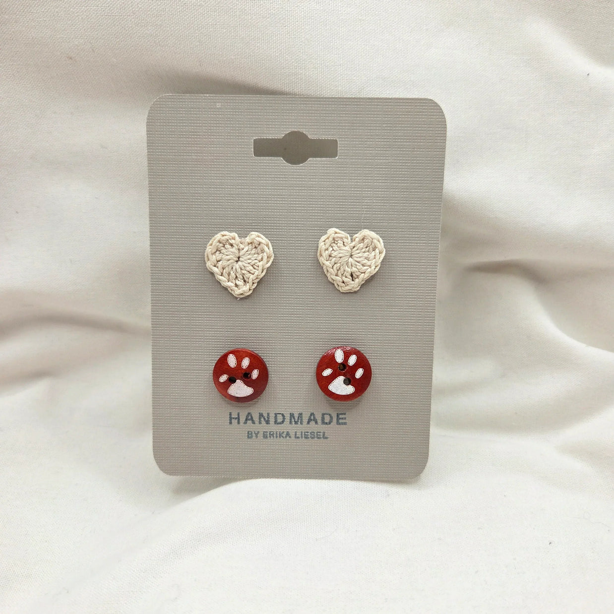 Handmade crochet heart and paw print buttons on display card, cozy craft gift set