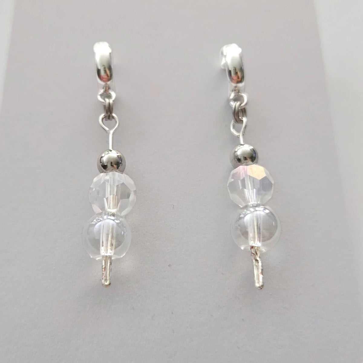 Handmade by Erika Liesel silver crystal half-hoop drop earrings with round beads and a polished silver-tone finish.