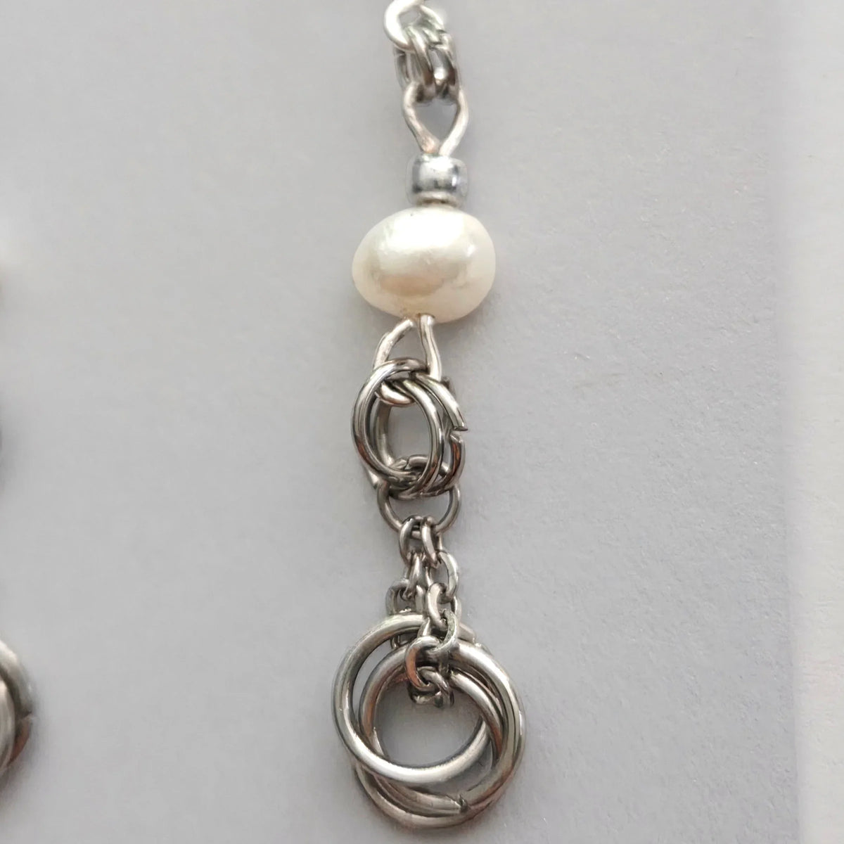 Handmade by Erika Liesel silver freshwater pearl drop earrings with delicate chain and linked ring detailing