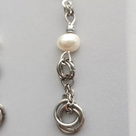 Handmade by Erika Liesel silver freshwater pearl drop earrings with delicate chain and linked ring detailing