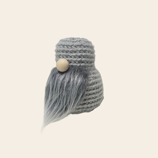 Handmade gray crochet gnome with wooden bead face and fluffy beard, cozy home decor