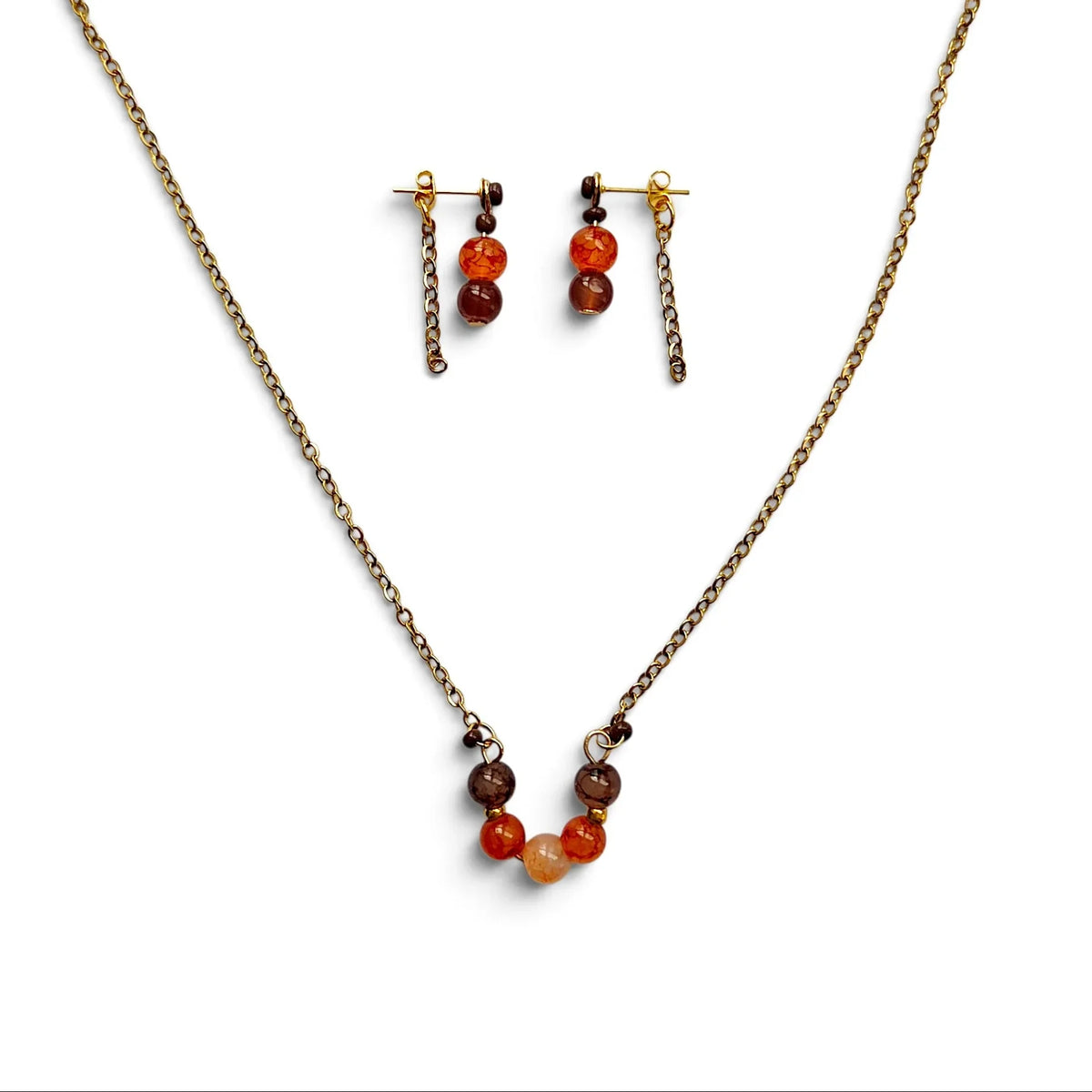 A jewelry set featuring a bronze chain necklace and matching drop earrings with small orange, brown, and red beads, displayed on a clean white background.