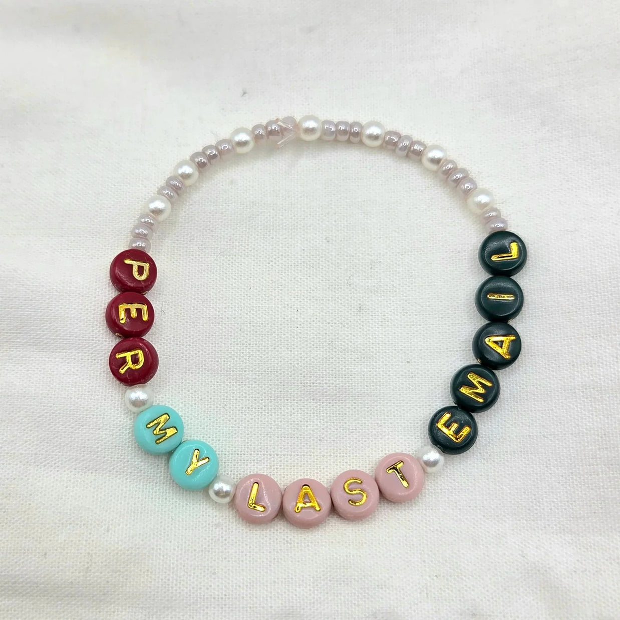 Personalized beaded bracelet with 'DEAR MY LAST NAME' in colorful letter beads and pearls, handmade gift