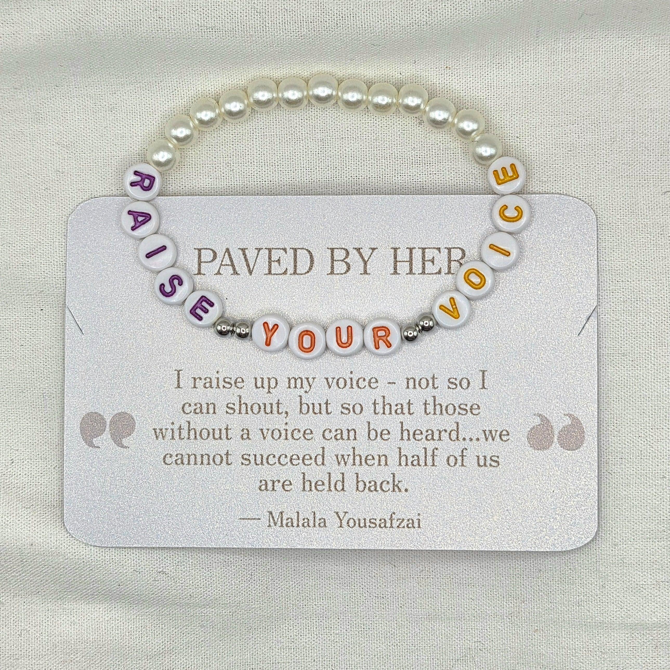 Raise Your Voice beaded bracelet with pearl accents, inspired by Malala Yousafzai's empowering quote on a shimmer card.