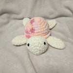 Handmade crochet turtle with pastel shell, cozy baby gift, soft amigurumi toy on blanket