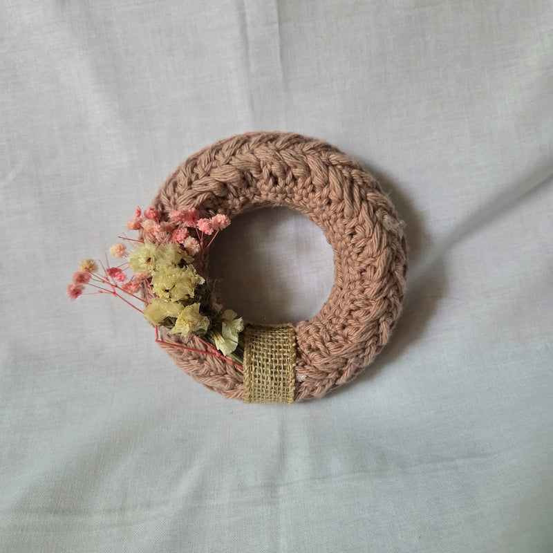 Handmade crochet wreath with dried pink and yellow flowers, rustic burlap ribbon, cozy home decor