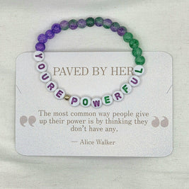You're Powerful beaded bracelet with purple and green beads on a card with inspirational quote