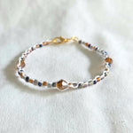 Handmade beaded bracelet with colorful crystals and gold clasp, perfect for cozy gifting