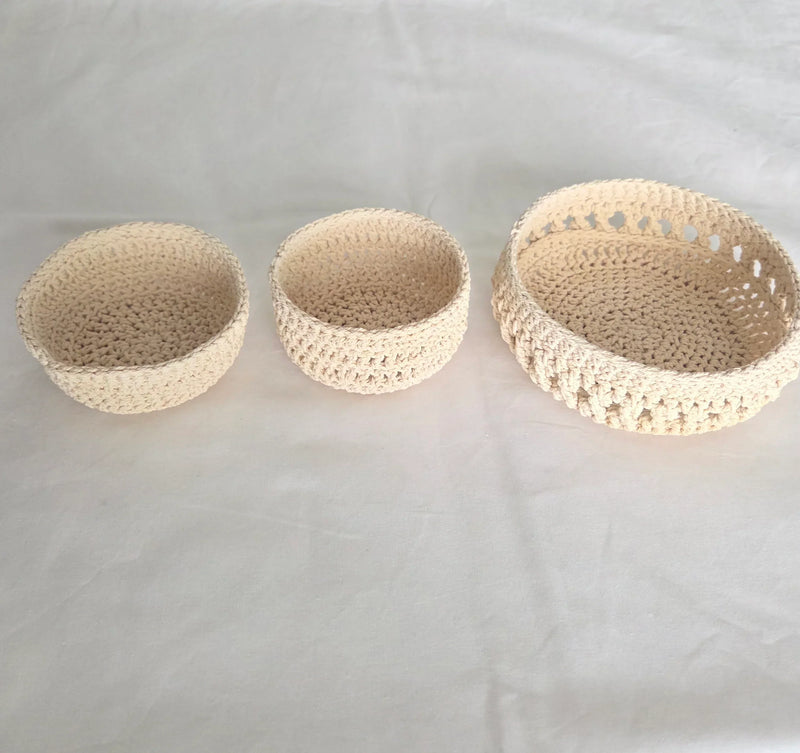 Set of three handmade crochet baskets in neutral tones, perfect for cozy home decor and storage