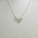 Delicate silver necklace with pearl and bead charms, perfect for everyday wear or gifting