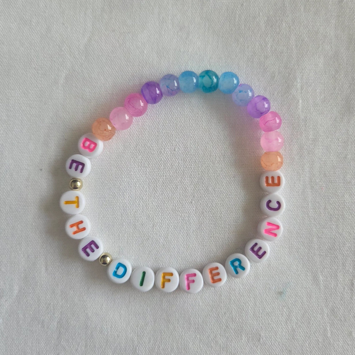 Colorful beaded bracelet with 'BE THE DIFFERENCE' message, handmade with vibrant beads