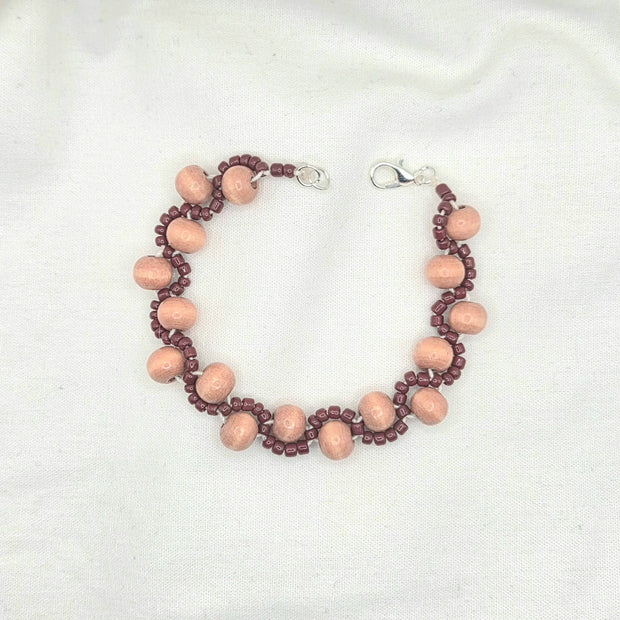 Handmade wooden bead bracelet with burgundy accents, cozy artisan jewelry for everyday wear